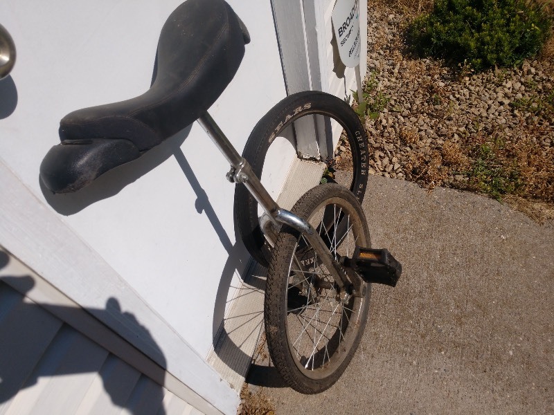lot 6 image: Vintage Unicycle and Vintage Huffy Cheater Slick XKE 990 20x2.125 Bike Tire