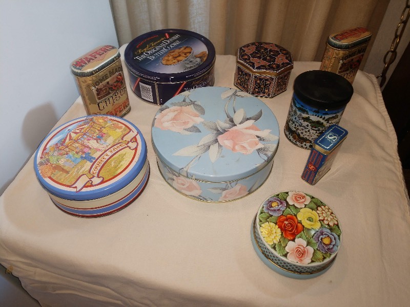 lot 79 image: Country Fair Tin, Homemade Ginger Wafers Tins (2), &nbspNavy The Original Danish Butter Cookies Tin, Pastel Blue wPink Flowers Tin, Rileys Toffee Lattice wFlowers Tin, Ship Golden Sovereign Merchantman Tin, Round Snowy Village Tin, Octagon Shaped Tin