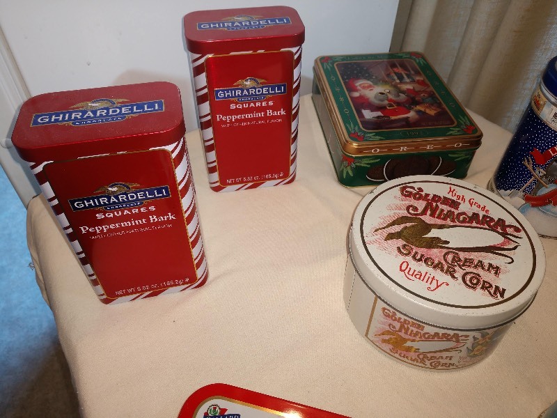 lot 82 image: Red Ghirardelli Peppermint Bark Tins (2), 1992 Oreo Unlock the Magic Tin, Altoids The Big Tin, High Grade Golden Niagara Cream Sugar Corn Tin, Hersheys Assorted Miniatures Let It Snow Tin, Peanut M&ampMs Tin, Plain M&ampMs Tin