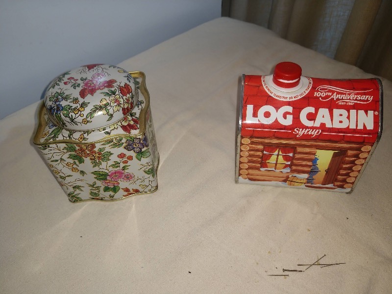 lot 93 image: 100th Anniversary 1887-1987 Log Cabin Syrup Tin and The Tin Box Co, of America Floral Tin 1987
