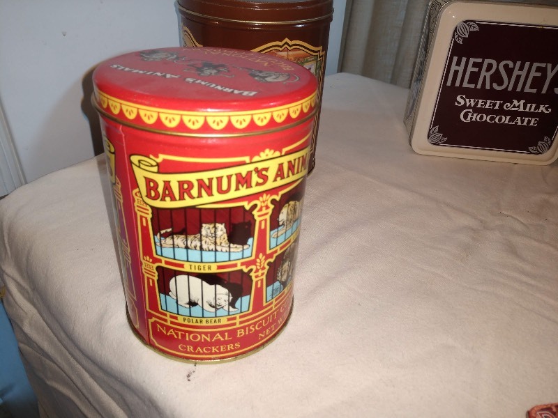 lot 100 image: Red Barnums Animals Crackers Tin, Brown Orville Redenbachers Quality Popping Corn Tin, Hersheys Sweet Milk Chocolate Tin, Pink Mom & Popcorn Tin, Green Spices Tins (2), Bens Cycle Repair Kit Tin