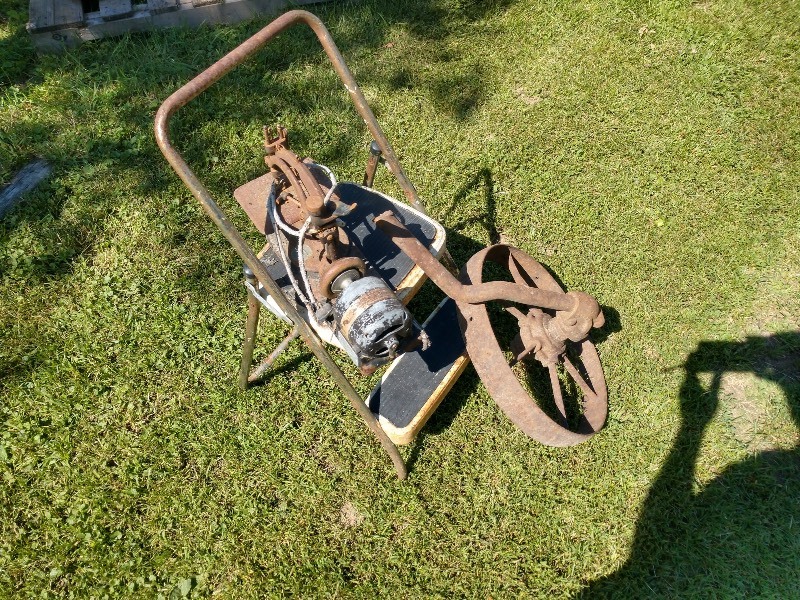 lot 16 image: Willcox & Gibbs Electric Sewing Machine Co. Sewing Machine and Cast Iron Wheel