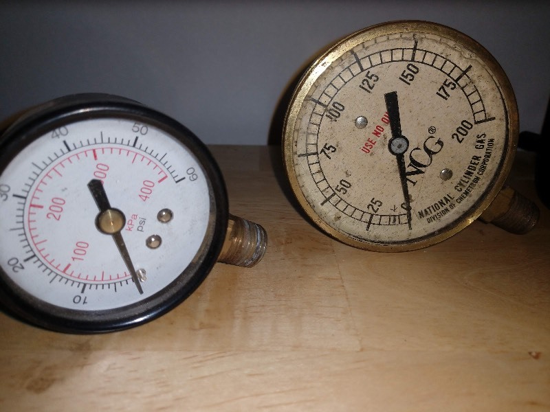 lot 11 image: Dual Scale 0400 kPA 060 psi Pressure Gauge, NCG 0200 Pressure Gauge, Vintage Marsh Instruments Company Boiler Temperature Pressure Gauge, International Harvester D-0-C Amp Gauge, Ashcroft 0100 Pressure Gauge