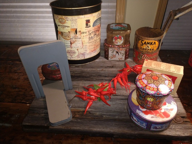 lot 47 image: Atwoods Coffee Can, Sanka Coffee Can, Five Meister Tins, Decorative Garland of Red Hot Chile Peppers, Pactra Namel Paint in Pink Pearl #44, Book Ends (3), Frost & Budd Metal Waste Basket
