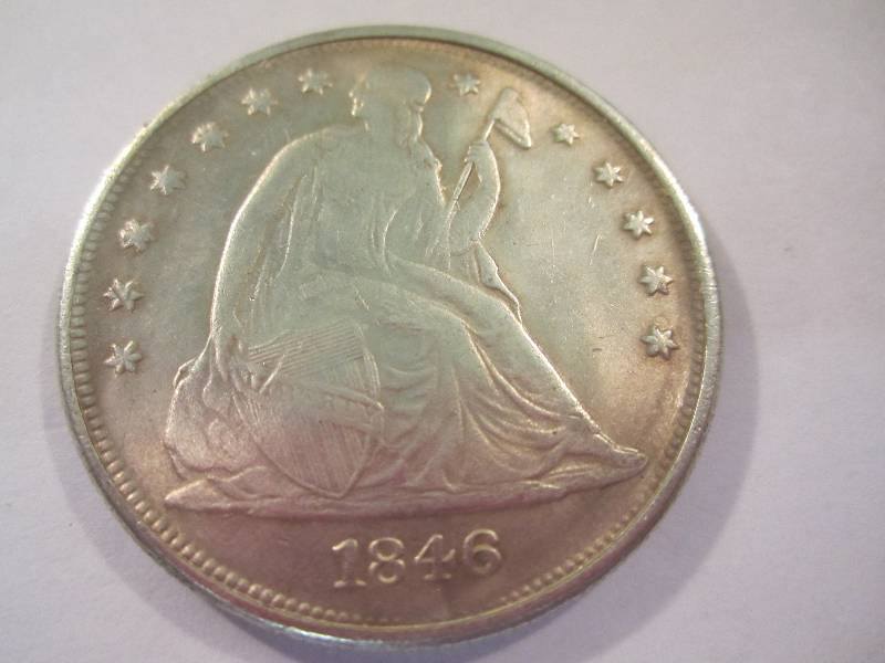 lot 17 image: 1846 CC One Dollar Coin Sticks to Magn...