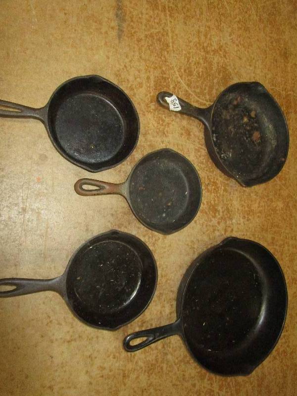lot 103 image: Cast Iron Pans,  One Wagner Pan (#6), 3 6 12 Pans, #8 Pan