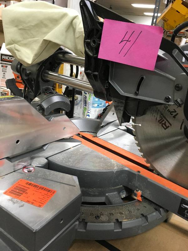 lot 41 image: Ridgid 15 Amp 12 in. Corded Dual Bevel Sliding Miter Saw with 70° Miter Capacity Used in working conditions