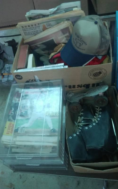 lot 92 image: 2-Boxes Lot Sports Related Newspapers & Magazines, Work Gloves, Caps, Pair Of Old Ice Skates
