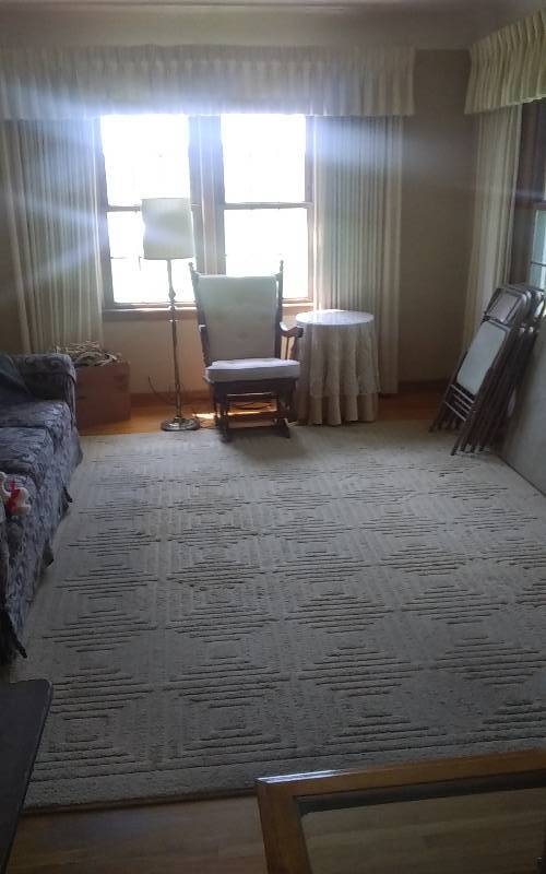 lot 149 image: Round Glass Top Table With Crocheted Cover 20x26, Vintage Platform Rocker, Floor Lamp, Area Rug 8x10 Beige