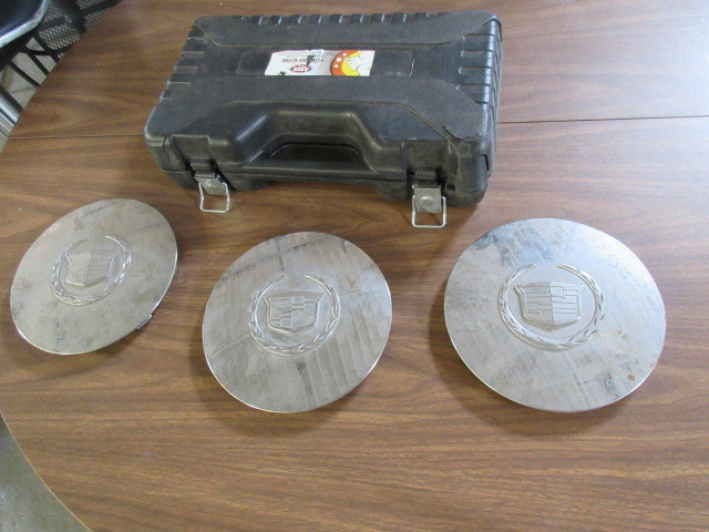 lot 338 image: NUT BUDDY AND 3 CADILLAC HUB COVERS.