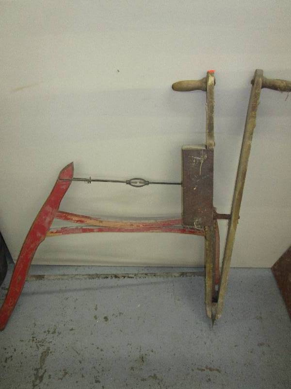Antique seed planter and buck saw