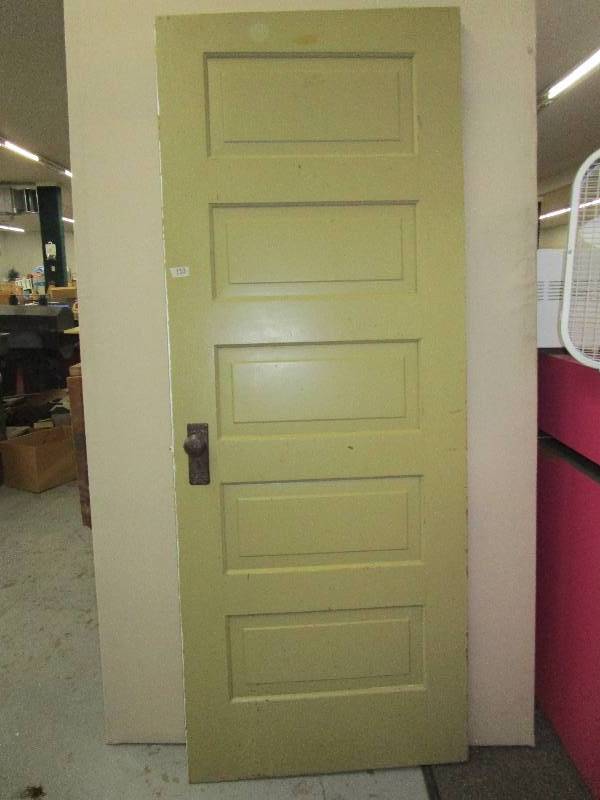 30X78Two colored wooden door. One side is green other side is white.