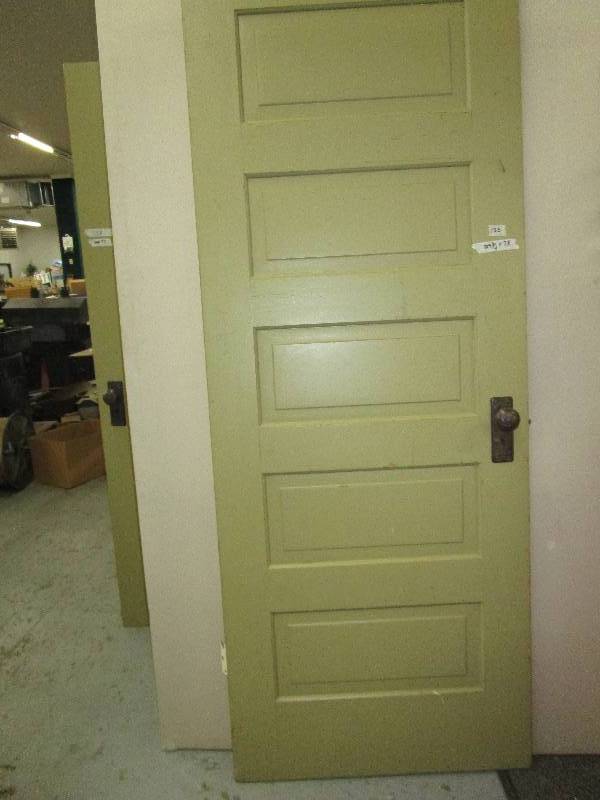 29 34X 78 two sided wooden door. One side is green other is white. White said has a coat hook attatched