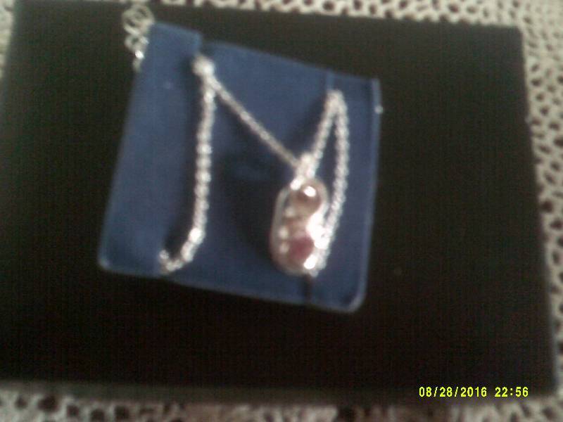 lot 27 image: SILVER KNECKLACE WITH PINK STONE IN BABY SHOE PENDANT