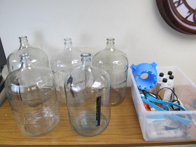 lot 102 image: 5 Large Glass 5 Gallon Carboy Jugs wBox of Brewing Supplies
