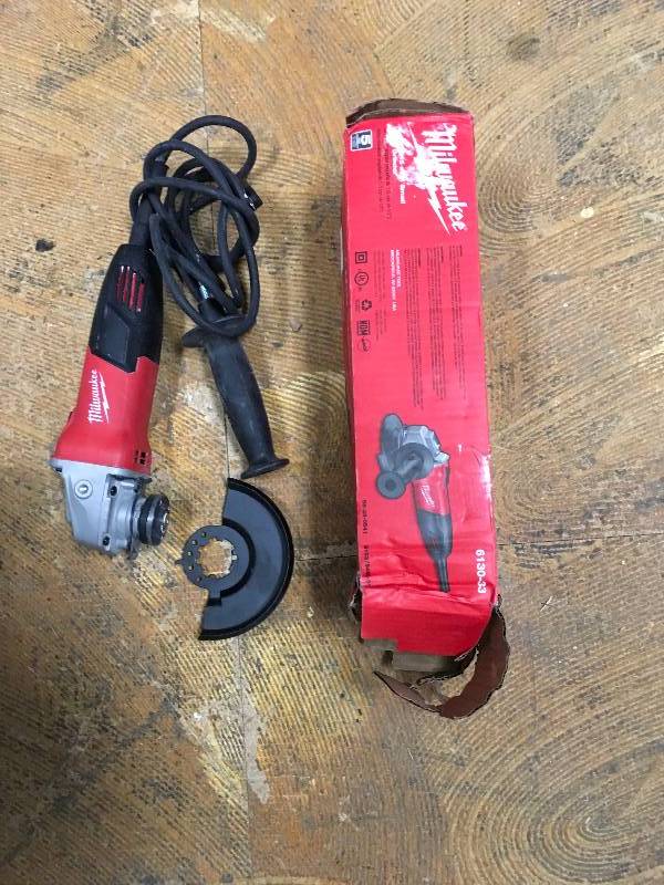 Milwaukee 7 Amp Corder 4-12 in. Small Angle Grinder with Sliding Lock-On Switch used in working conditions