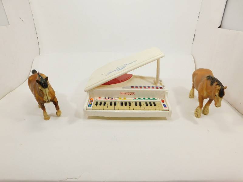 lot 44 image: Two Toy Horses & An Electronic Toy Grand Piano