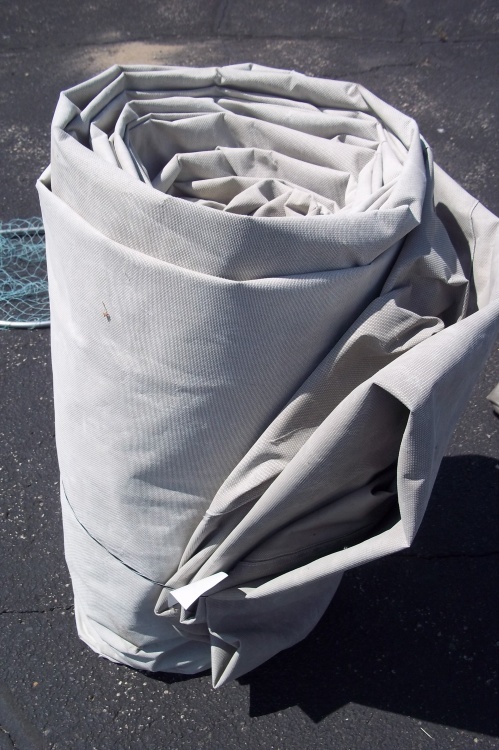 lot 23 image: Gray Tarp. May Have holes. Great For Wood Pile