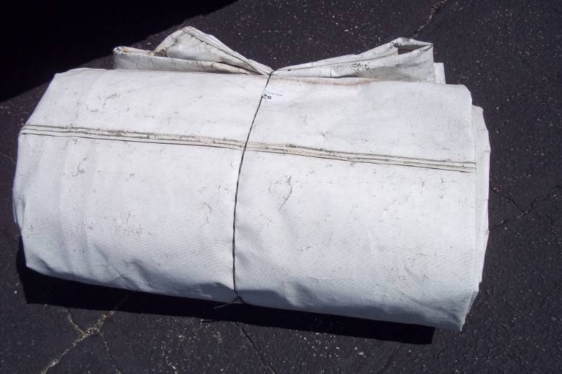 lot 26 image: Silver Tarp. May Have holes. Great For Wood Pile