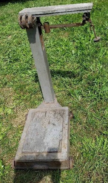 lot 12 image: Antique wood scale with metal base and wheels