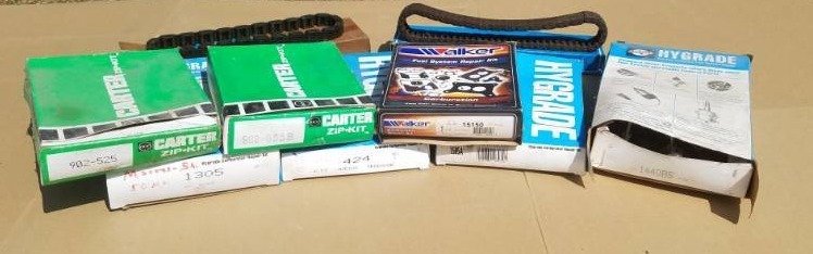 lot 221 image: Carburetor kits and two timing chains Ford