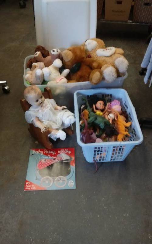 lot 26 image: Bin Of Stuffed Animals, Bin Of Rubber Dinosaurs, Oak Rocking Chair, Vintage Baby Doll