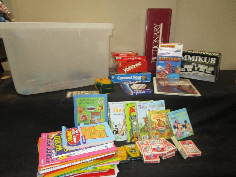 lot 27 image: Golden Books, Connect 4, Coloring Books, Tablets, Yatzee, Pictionary, Battleship, Rummikub, Crayons, Cards, Chalk, Large Tub