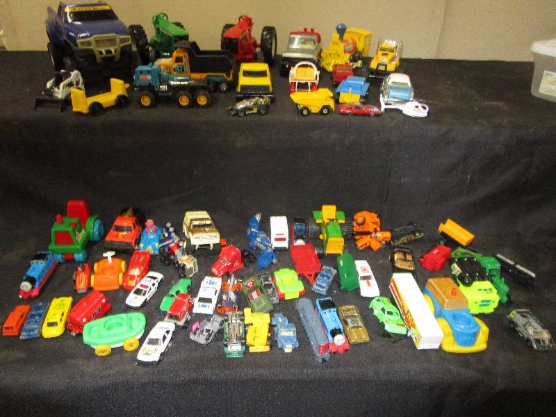 lot 28 image: 65 misc. Toys, Trucks, Cars, Tractors, Bobcat, Hotwheel, Helicopters, Trains