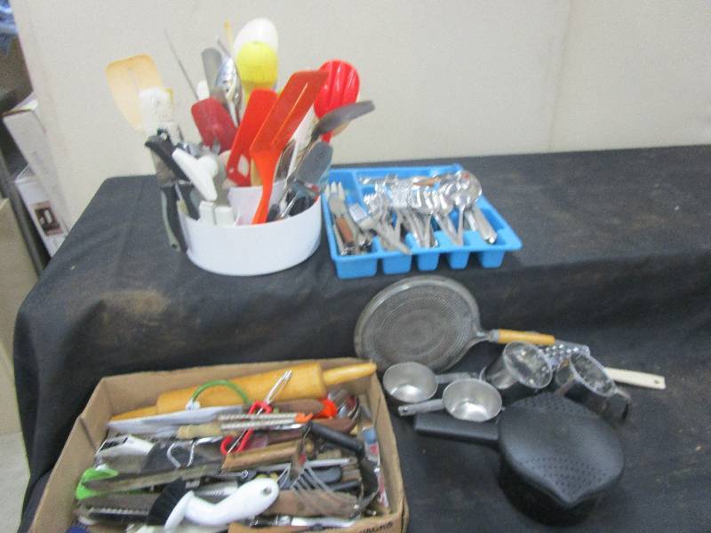 lot 37 image: Lots of nice silverware and kitchen stuff. Measuring cups, utinsil holder, sifters, Pampered chef items tool turn about and microwave steamer and so much more