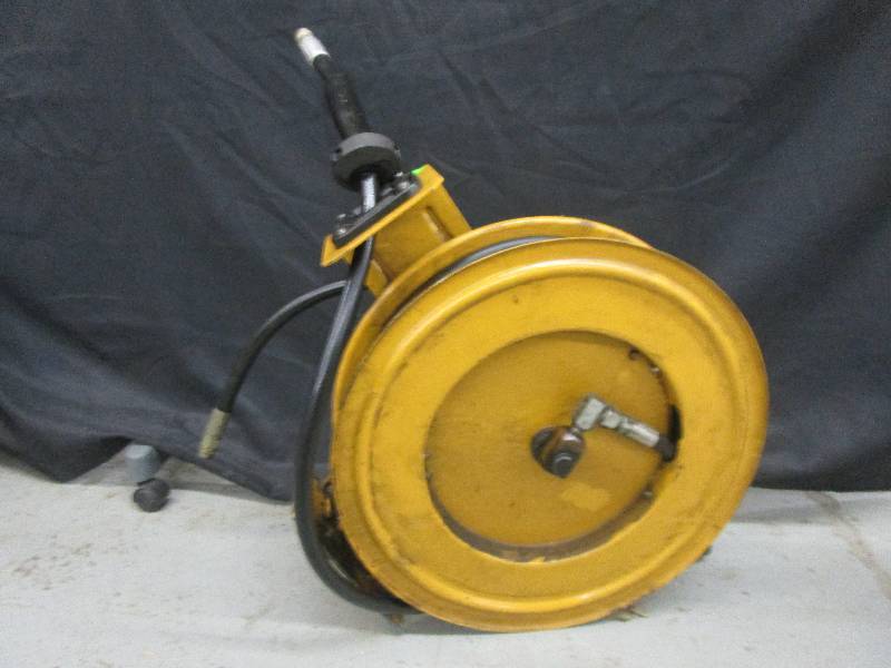 lot 58 image: Oil hose and reel (Yellow) bracket to hang on wall