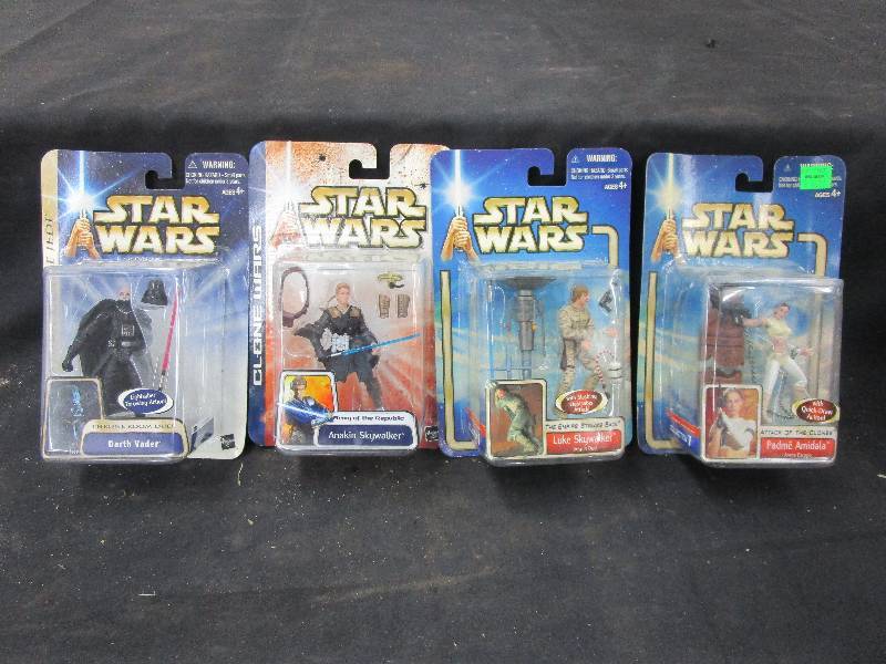 lot 143 image: Star Wars unopened in packages Padme Amidala with quick draw action, Darth Vader Retrun of the Jedi Throne Room Duel Anakin Skywalker Clone Wars Army of the Republic Luke Skywalker The Empire Strikes Back With slashing lightsaber attack