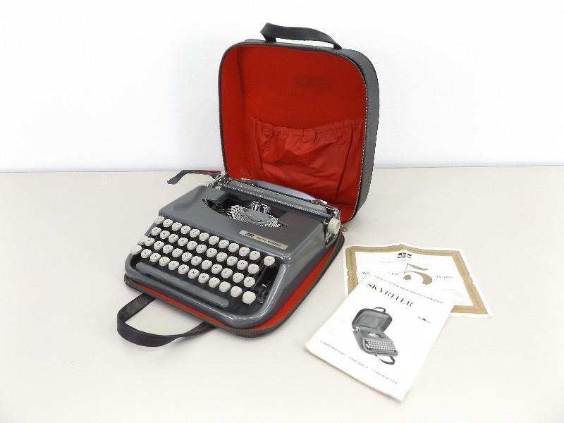 lot 8 image: Vintage Smith-Corona Skyriter Portable Typewriter with Instructions