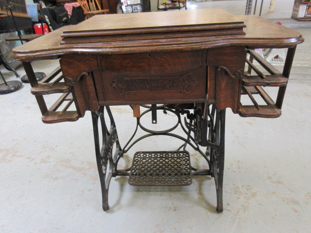 lot 264 image: VINTAGE NEW HOME SEWING MACHINE AND CONSOLE