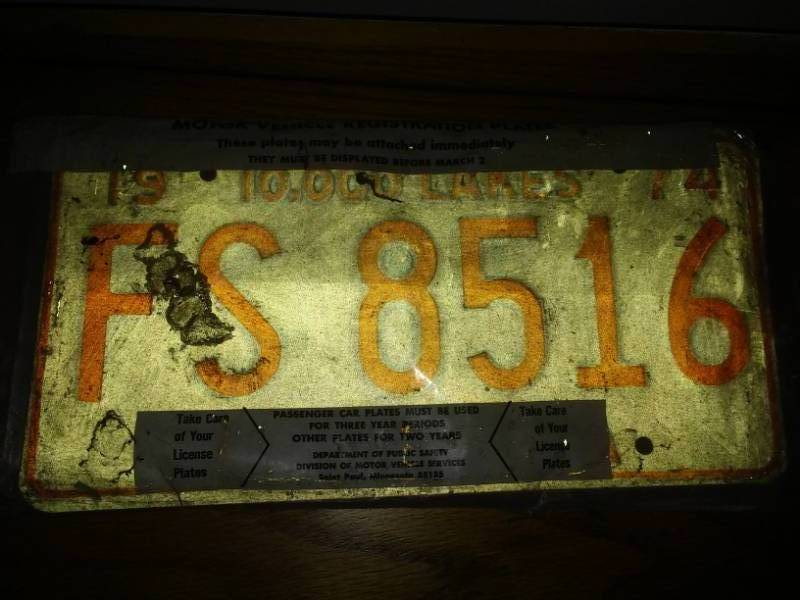 lot 354 image: 2 new 1974 license plates in DMV bag