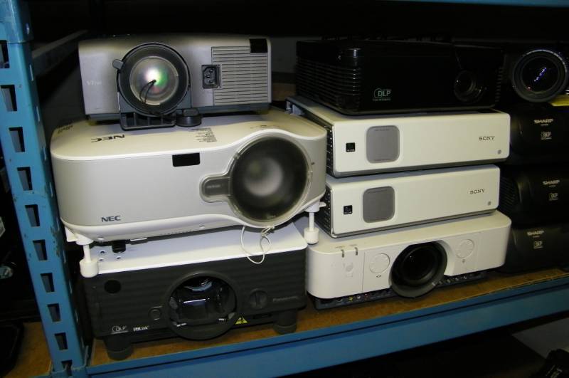lot 120 image: (8 Wide Shelf - LARGE LOT)  Professional Projectors - Sony, Sharp, NEC and more for PARTS  REPAIR