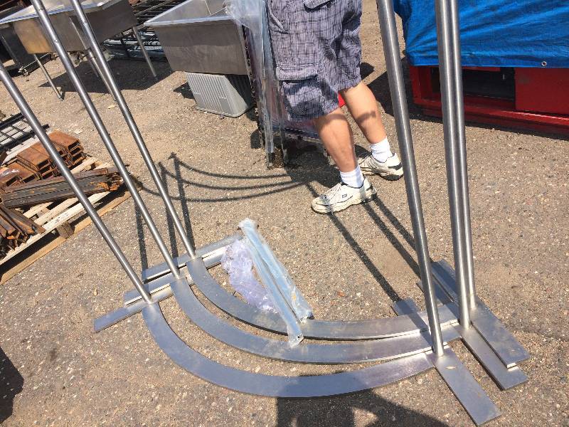 lot 55 image: Crescent shape polished steel display rack