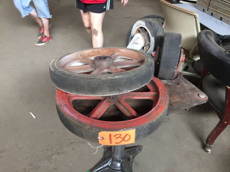 lot 130 image: Heavy cast-based rubber coated spoke and axle wheels