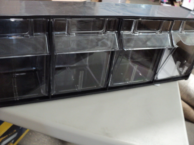 1 black hanging unit with 4 plastic...
