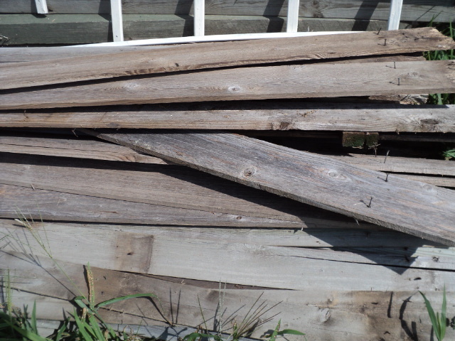 pile of grey weathered fence boards...