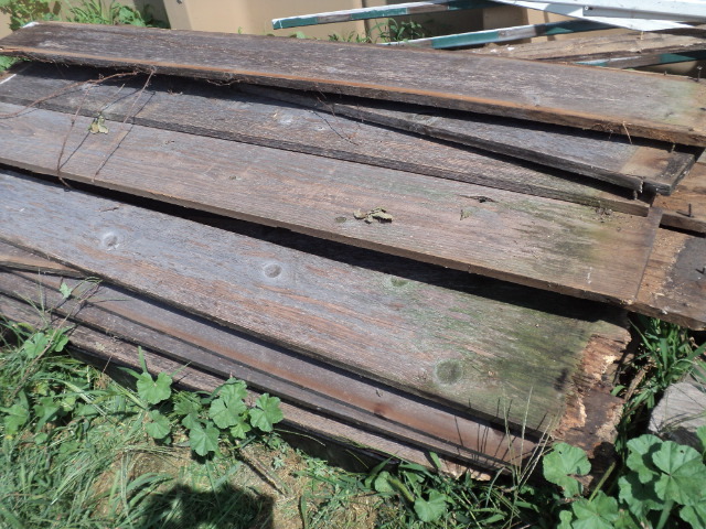 pile of grey weathered fence boards...