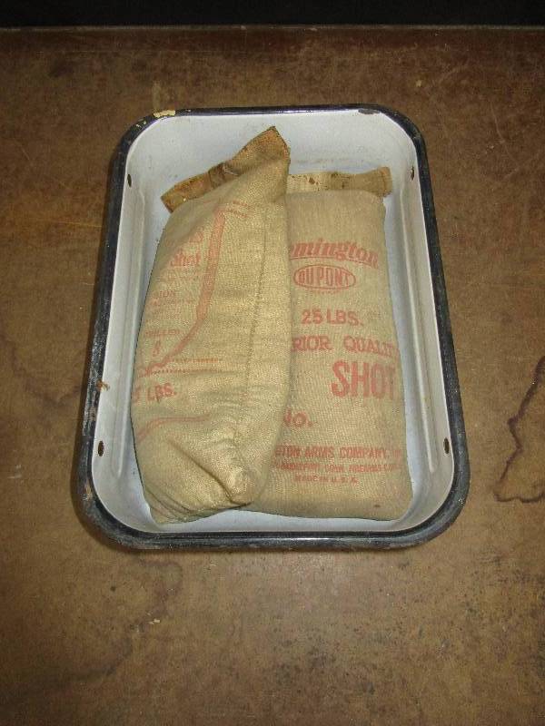 lot 73 image: Enamel pan and old steel shot bags full of sand for dcor