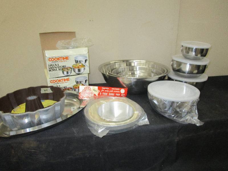 lot 112 image: Stainless mixing and serving bowls Nesting and some with covers, bundt pam, 3 tier cake pans  Unused