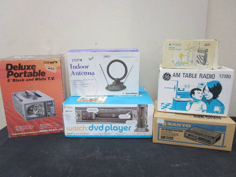 lot 115 image: 5 Portable Black and White T.V., TV FM antenna, remote control DVD player, FMAm Pocket radio, GE am Table radio, am fm digital Clock Radio all NEW in the box and old Vintage answering machine not new
