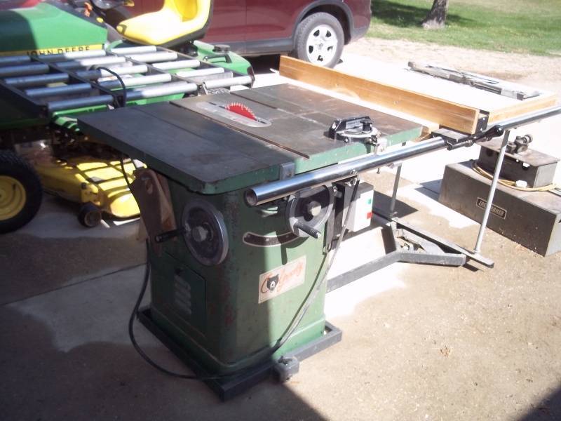 lot 15 image: Grizzly 10 Table Saw with roll off table and is on rollers.
