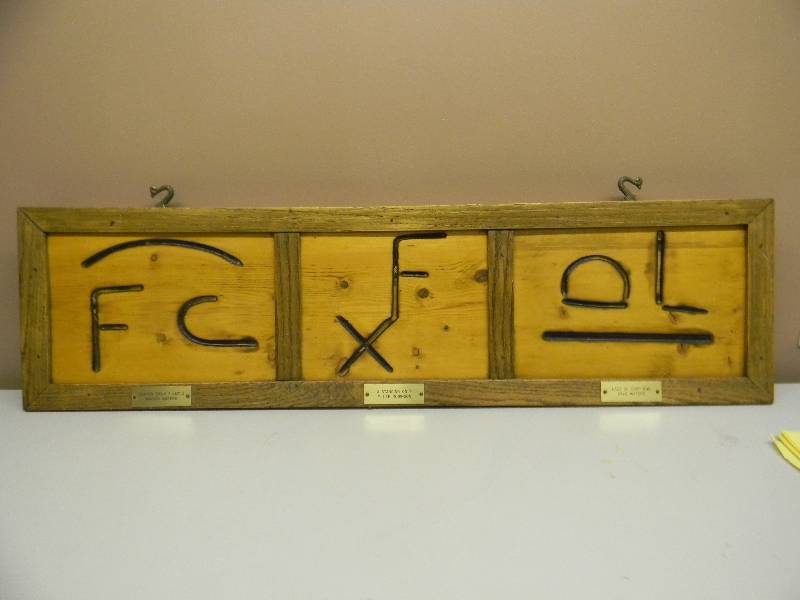 lot 10 image: VINTAGE BRANDING IRON WALL HANGING - VERY UNUSUAL PIECE - APPROX 38 BY 10 - SEE PICTURES