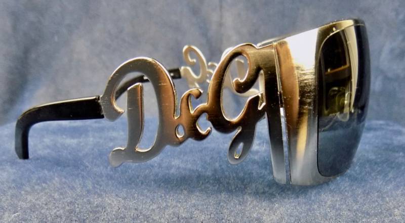 lot 17 image: Authentic D&G Dolce & Gabbana Grey 6019 Sunglasses  & An Empty Coach Sunglass Case