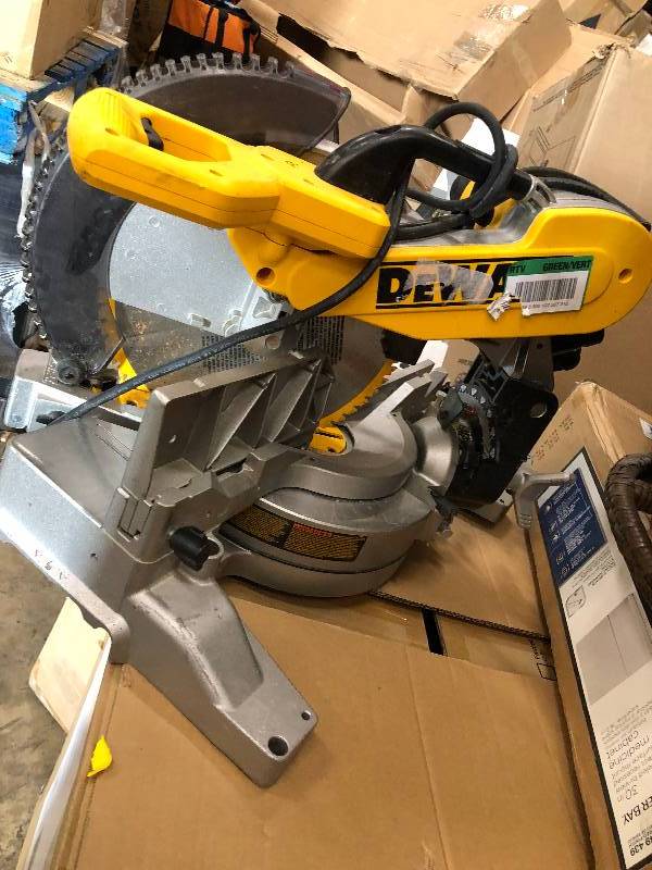 lot 115 image: DEWALT 15 Amp 12 in. Double-Bevel Compound Miter Saw used in working conditions