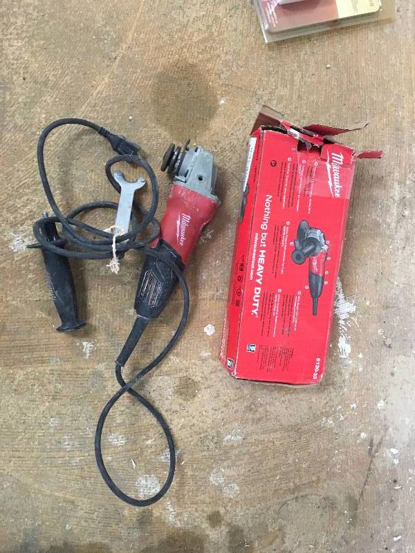 lot 53 image: Milwaukee 7 Amp Corded 4-12 in. Small Angle Grinder with Sliding Lock-On Switch Used in good working cond.  Missing Guard