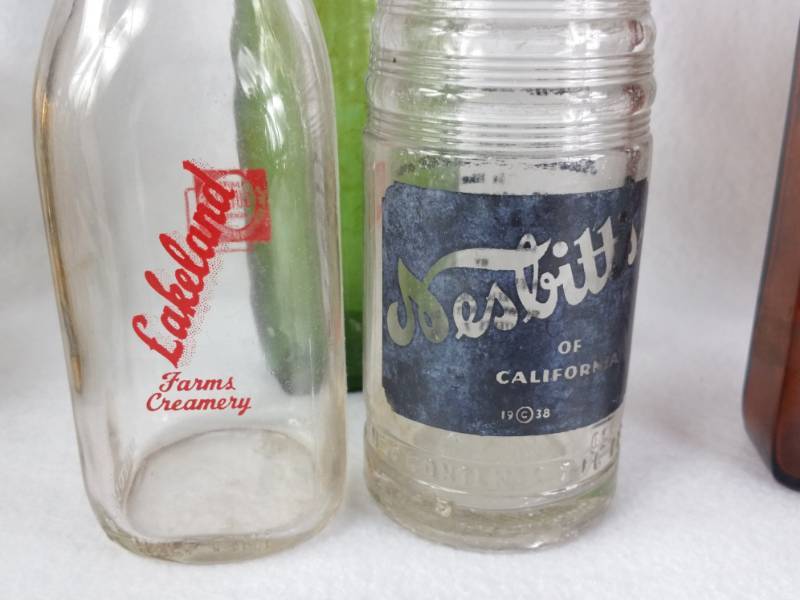 lot 52 image: Large Group of Antique and Vintage Glass Drug Store, Nesbitt, Lakeland Creamery Milk Bottle, etc.