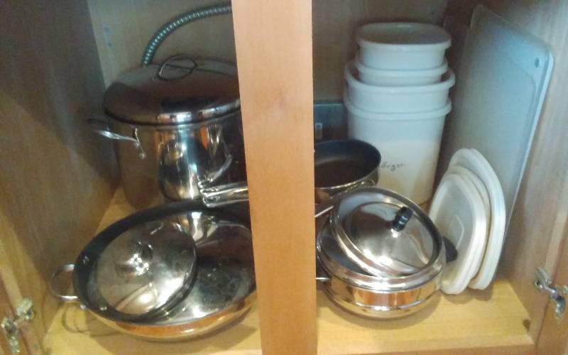 lot 48 image: Contents Of Kitchen Cabinet  Farberware Pots & Pans, Tupperware Canisters, Cutting Boards